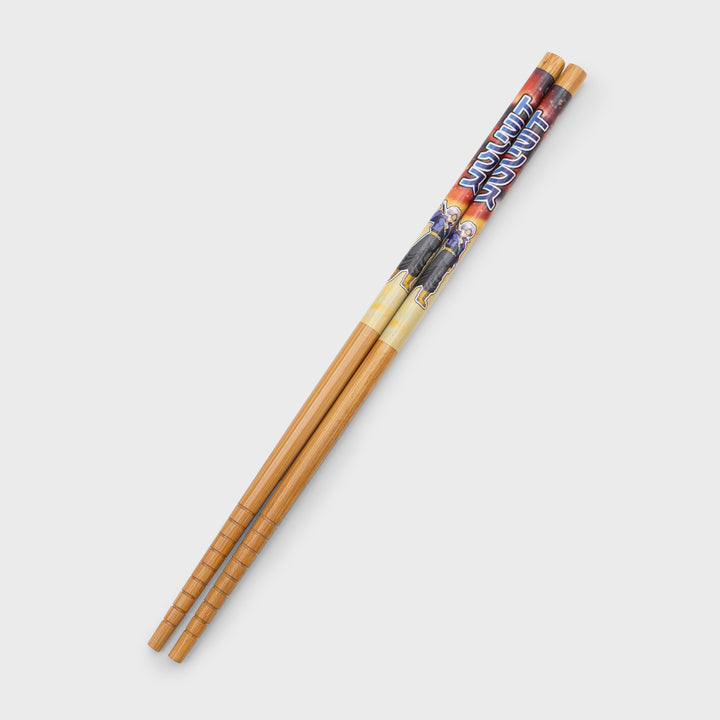 pair of wooden chopsticks. has trunks on top of each.