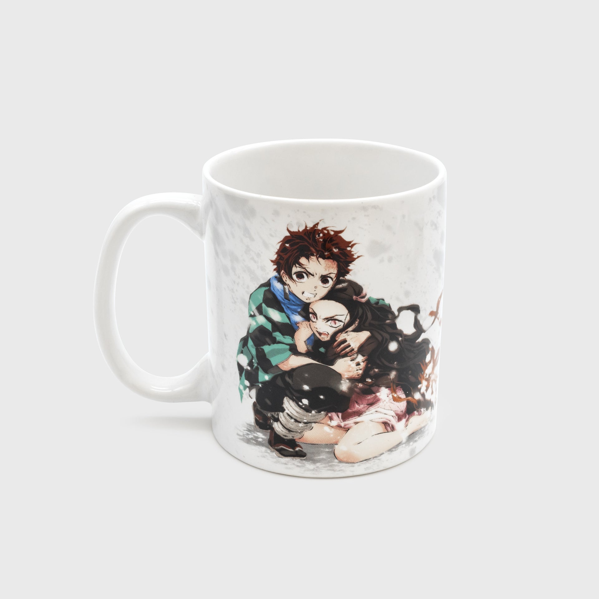 ceramic mug. image on mug: demon slayer's characters tanjiro and nezuko holding each other in the snow.