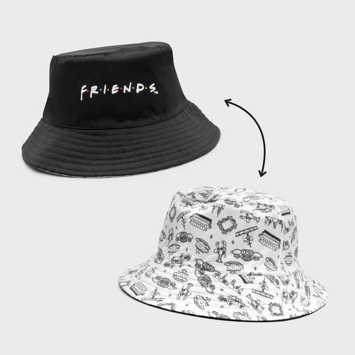reversible bucket hat. one side is black with friends logo. other side is white with black friends symbols. couch, central perk sign, coffee cup, lobster, picture frame, fountain, new york city, taxi cab.