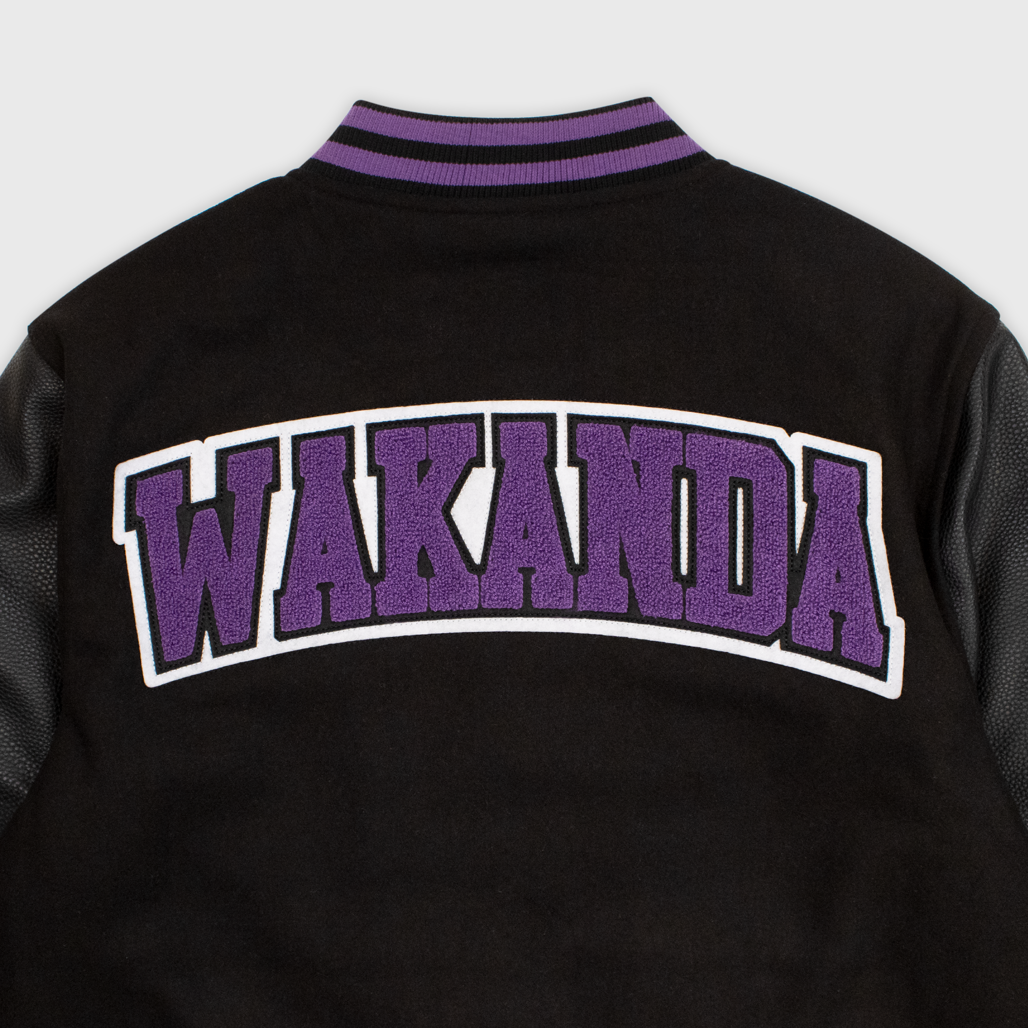 close up of back of jacket. patch says WAKANA in purple letters.