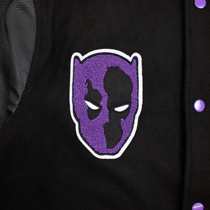 close up of black panther mask patch. purple and black.
