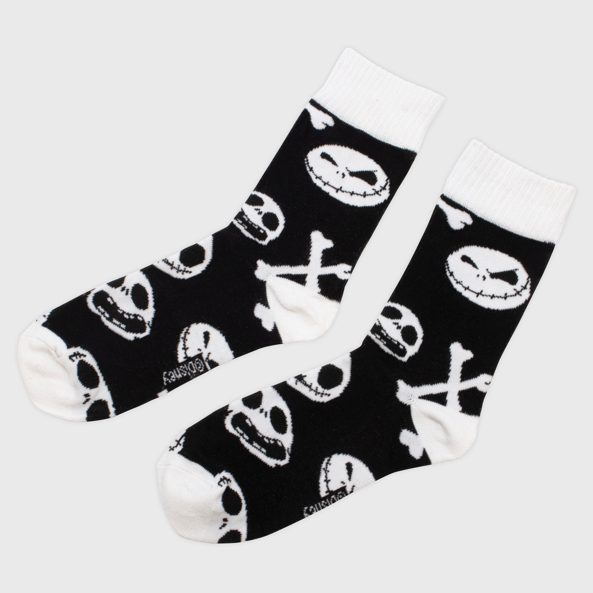 nightmare before christmas crew socks. pattern: jack skeletons faces and cross bones.