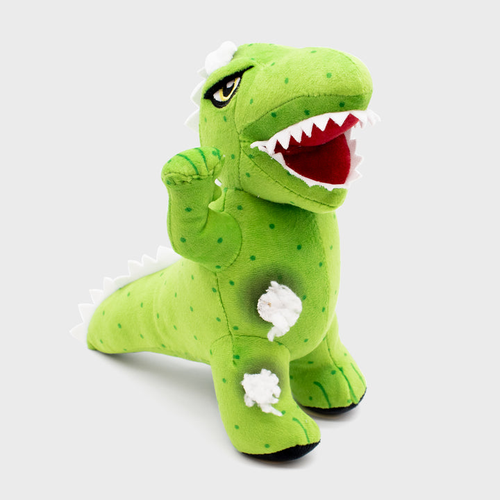 dinosaur plush. fake stuffing coming out of belly and leg.