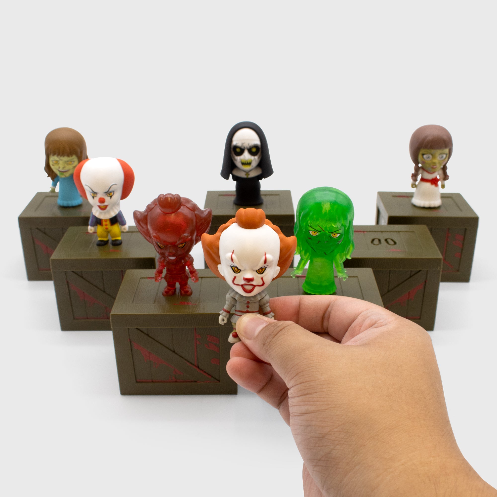 Full set of Horror Smols. Includes Pennywise (1990), Pennywise (2017), Translucent Red Pennywise (2017), The Nun, Annabelle,  Regan, Translucent Green Regan 