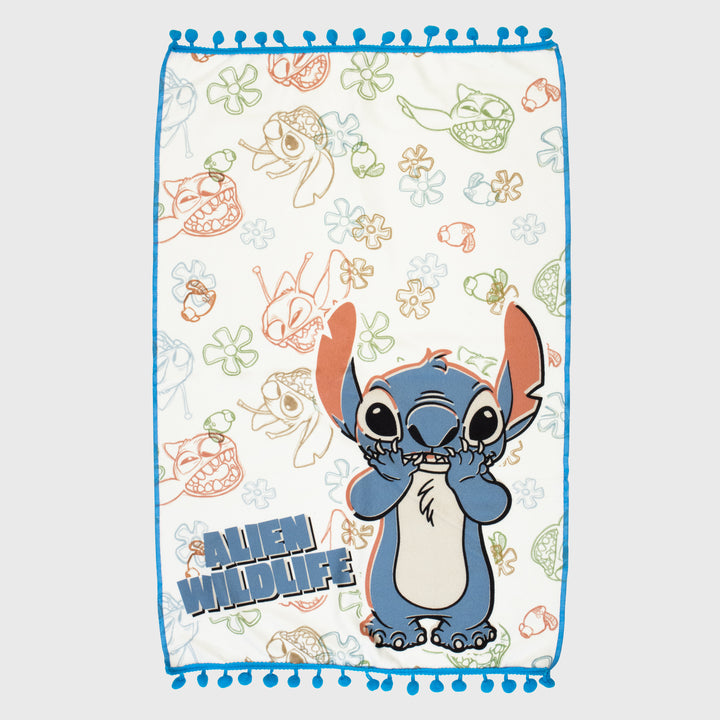 kitchen towel shows stitch holding his face. pattern of different stitch faces and flowers: text: alien wildlife.